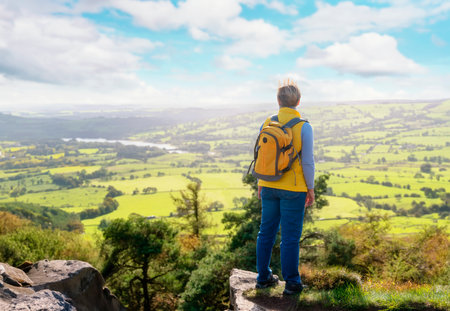 Stunning Woman reaching the destination and taking selfie, photos, and shouting on the top of mountain Travel Lifestyle concept The national park Peak District in Englandの写真素材