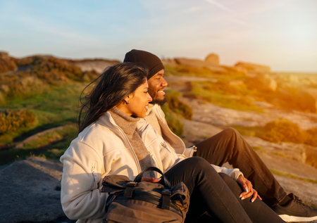 happy couple in love walking along countryside at the sunset. Love, hiking and active lifestyle conceptの写真素材