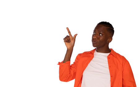 woman with slight grimace and index finger pointing up presenting copy space on white backgroundの写真素材