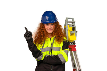 cheerful apprenticeship female site engineer surveyor in safety equipment lifting her forefinger as idea on white backgroundの写真素材