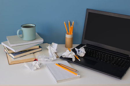 Front view on modern creative workspace of a creative entrepreneur with mess on the office table...