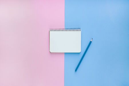 Spiral notebook or sketchbook on pink and blue background with copy spaceの写真素材