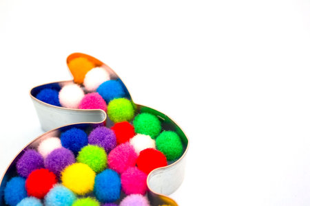 Close up of rabbit bunny shaped form for gingerbread or cookies decorated with colorful balls inside...
