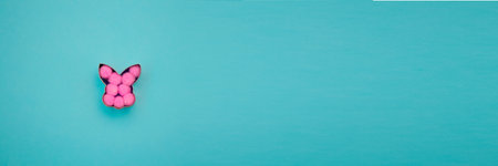 Banner with rabbit bunny shaped form for gingerbread or cookies decorated with pink balls inside on...