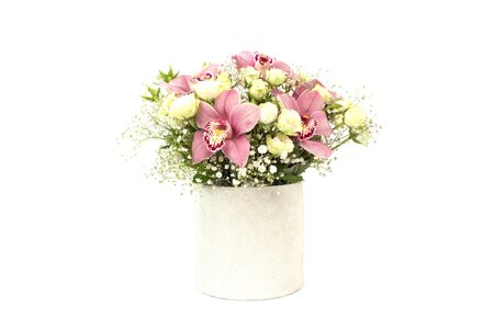 Beautiful bouquet of orchids, roses and gypsophila, Baby's-breath flowers in decorative paper tube packaging isolated on white, copy space. Selective focus, celebrating or delivery flowers conceptの写真素材