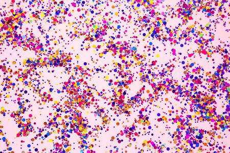 Colorful sparkles on trendy pink pastel background for your creative projects and design, festive celebration concept. Selective focusの写真素材