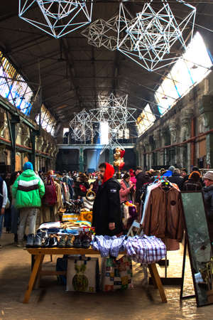 Lviv, Ukraine - February 16, 2020 : people shopping on garage sale in Lem Station, Tlum and Kram. Vintage clothes, other goods on flea market. Thrift shopping or donation concept. Vertical compositionのeditorial素材