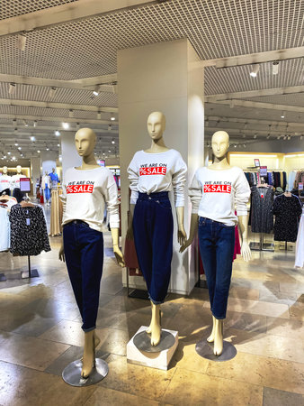 Lviv, Ukraine - June 12, 2020 : Forum shopping mall, mannequins wearing white sweaters with red inscription - WE ARE ON SALE. Seasonal sale or Black Friday conceptのeditorial素材