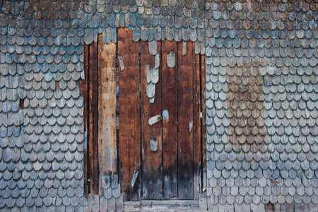 Wooden wall background with made with old weathered roof shingles with remnants of blue paint, with copyspace for your text or creative design, natural cracked surface. Shabby vintage textureの写真素材