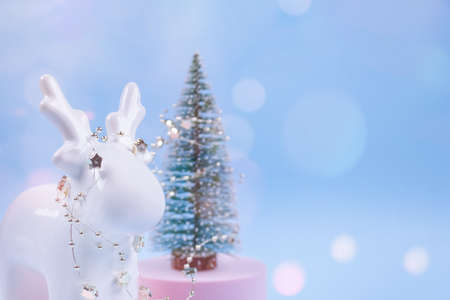 Christmas tree decorations on festive blue background with blurred bokeh and copyspace for your text. Christmas or New Year celebration concept. Christmas deer - as traditional symbolの写真素材