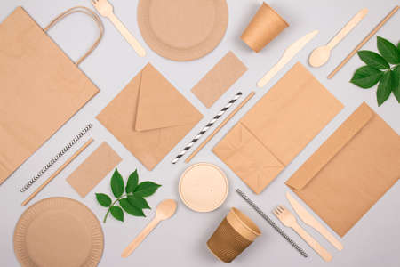 Flat lay composition with eco-friendly tableware - kraft paper food packaging on light grey background. Street food paper packaging, recyclable paperware and zero waste packaging concept. Mockupの写真素材