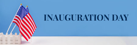 Banner with USA flags on white table against blue wall background, copy space for your text. Inauguration Day 2021 conceptの写真素材