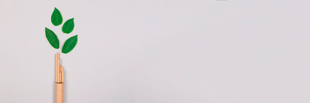 Banner, mockup image of brown paper straws packed in kraft paper tube or container with green leaves...