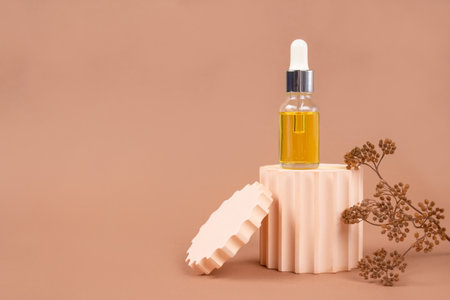 Mockup image of dropper bottle with modern organic cosmetics - polyglutamic or hyaluronic acid, serum, moisturizer, facial anti-aging oil. Trendy neutral biege still life composition. Selective focusの写真素材