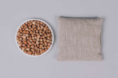 Cherry stone pillows, cherry pit filled pillow - natural heat or cool pack. Alternative medicine and therapy, pit sack for spa massage, chiropractic care and home health. Copy space and mockupの写真素材