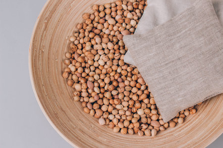 Cherry stone pillows in a bowl with cherry stones, cherry pit filled pillow for spa massage - natural heat or cool pack. Alternative medicine and therapy, pit sack for chiropractic care. Mockupの写真素材