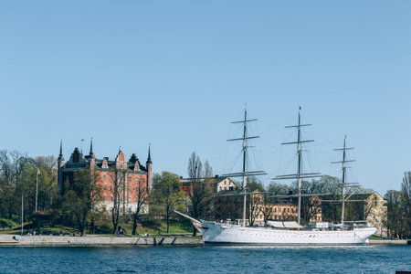 Stockholm, Sweden - May 1, 2019 : Scenic sunny day panorama of Stockholm city. City quay with passenger boat. City tour concept and spring vacation in Sweden. Selective focusのeditorial素材