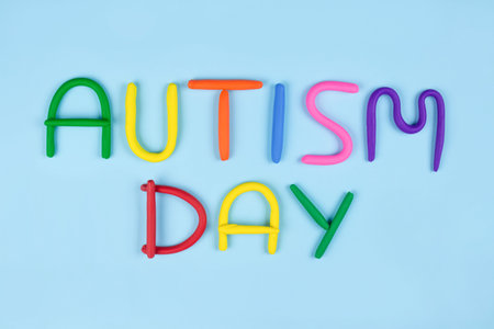 World Autism Awareness Day concept - multicolored letters made of play-doh or other sensory playfoam...