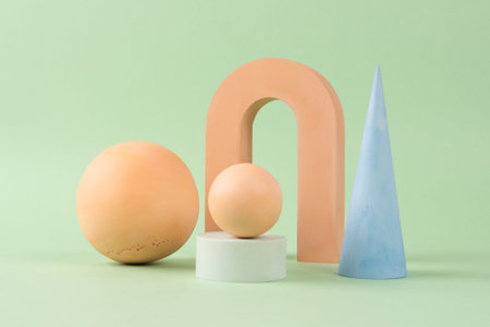 Modern still life composition with modern plaster shapes - balls, arch, cone in light beige and blue...