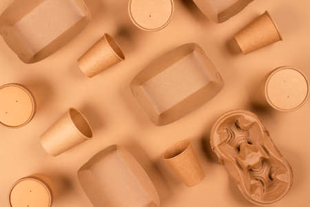 Flat lay composition with eco-friendly tableware and kraft paper food packaging on kraft paper background. Sustainable packaging concept, zero waste packaging concept. Selective focus. mockupの写真素材