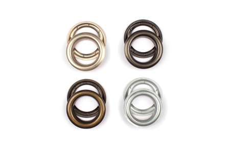 Different brass multicoloured metal eyelets or rivets - curtains rings for fastening fabric to the...