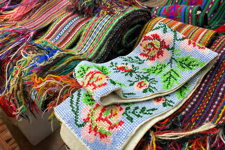 Close up of ukrainian clothes - traditional embroidered shirts and beaded belts. Secondhand goods on...
