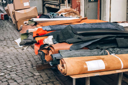 Natural leather of high quality in rolls for sale in the street, leather manufactory. Materials for handmade leather craft and sewing furniture, selective focusの写真素材