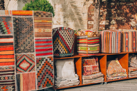 Carpet store with variety of traditional oriental carpets, rugs, pillows and poofs with decorative...