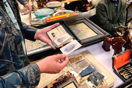 Lviv, Ukraine - May 16, 2021 : man buying old vintage photos and documents on garage sale in Lem...
