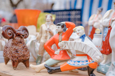 Vintage porcelain figurines on flea market. Old soviet figurines from ussr, collectibles memorabilia concept. Vintage decorative things on garage sale. Selective focusの写真素材
