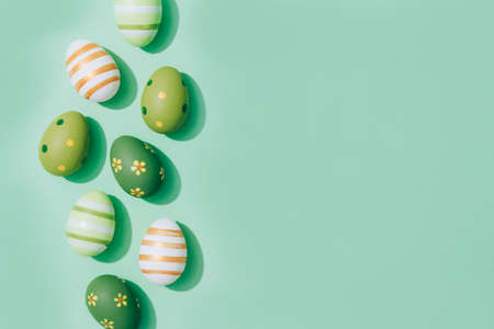 Easter eggs on pastel mint background with copy space for text. Easter greeting card concept. Flat lay. Selective focusの写真素材