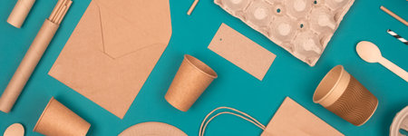 Banner. Flat lay with eco-friendly tableware and sustainable packaging. Paper food packaging on...