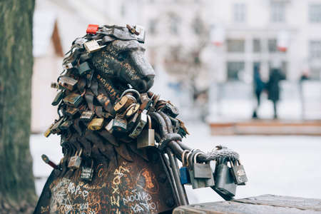 Lviv, Ukraine - January 19, 2022 : various love locks on the bench with bronze lions sculpture in the center of old town of Lviv. Lviv tourist attraction. Love padlocks placeのeditorial素材