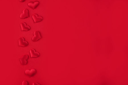 Festive St. Valentines backdrop with red hearts on red background with copy space. St.Valentines day...