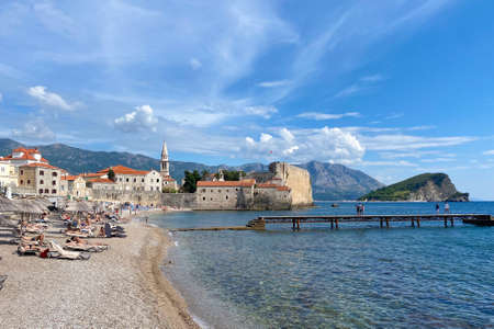 Budva, Montenegro - September 2021 : View on old town Budva from Adriatic sea coast. Summer tourist season, sea beach with many touristsのeditorial素材