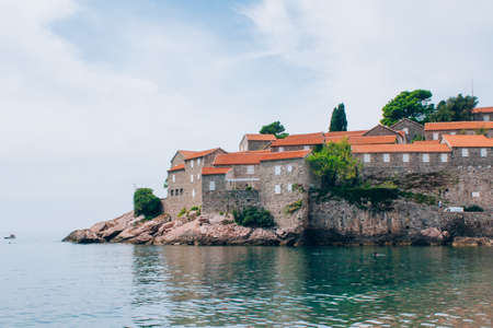 Sveti Stefan Island in Budva, Montenegro in autumn day. Beautiful view on island from the Adriatic coastline, selective focusのeditorial素材