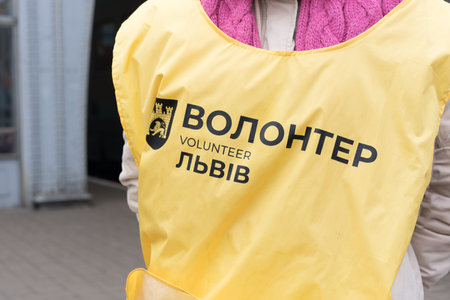 Lviv, Ukraine - March 8, 2022 : Lviv city volunteer. Volunteers at Lviv railway station and refugees center helping people. Selective focusのeditorial素材