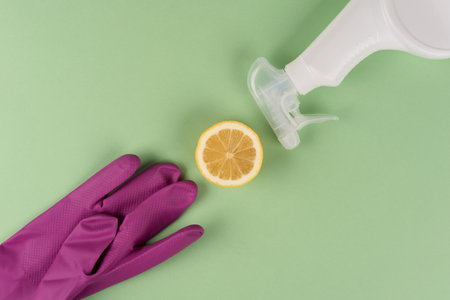 Bio organic detergent products. Natural household cleaners - spray bottle and lemon on green background. Homemade improvised cleaning products, air freshener or natural washerの写真素材