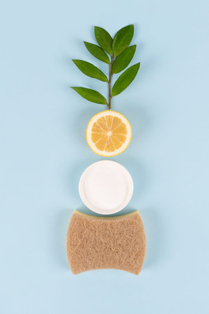 Natural household cleaners - baking soda, lemon, citric acid on blue background with copy space. Bio...