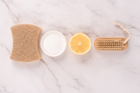 Flat lay composition with natural household cleaners kit with eco ingredients - bamboo brush, lemon,...