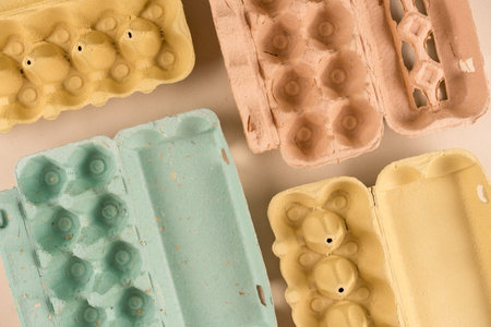 Different pulp egg cartons made with pulp and straw as background with copy space. Eco friendly egg...