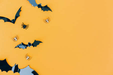 Halloween background with copy space for text - black decorative bats over orange background. Minimal Halloween conceptの写真素材