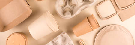 Banner with paper utensils over light background. Street food sustainable paper packaging. Eco- friendly food containers, cups, plates and paper bags. Monochrome flat lay compositionの写真素材