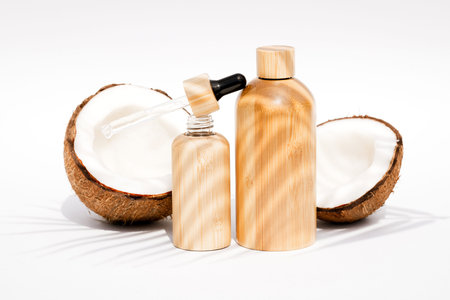Coconut beauty skincare products. Bottles with coconut cosmetic complex - oil and body milk or...