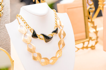 Vintage imitation jewelry background. Old-fashioned elegant necklaces. Vintage goods at flea market. Garage sale concept. Selective focusの写真素材