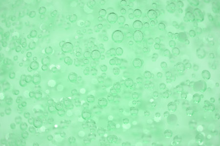 Texture of aloe vera cosmetic gel or face serum as background with bubbles and copy space. Natural...