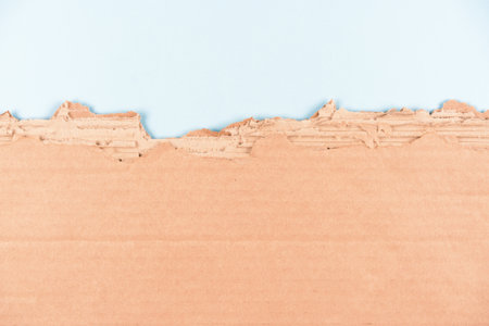 Corrugated cardboard sheet over light blue background as eco background with copy space for ecological project or paper packaging industry. Selective focusの写真素材