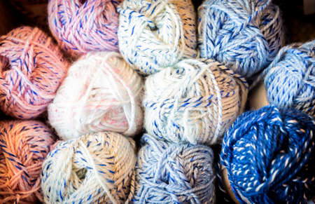 Colorful melange yarn balls on a shelf in a retail storeの写真素材