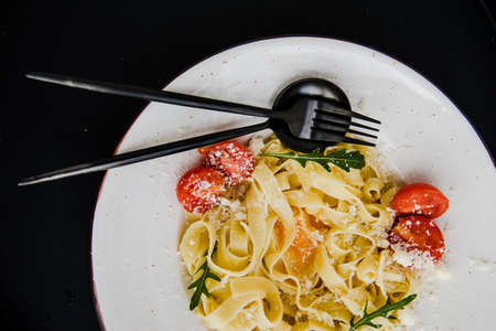 Classic italian spaghetti pasta with cherry tomatoes and cheese parmesanの写真素材