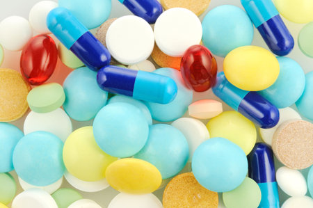 Background with different colour tablets and pills